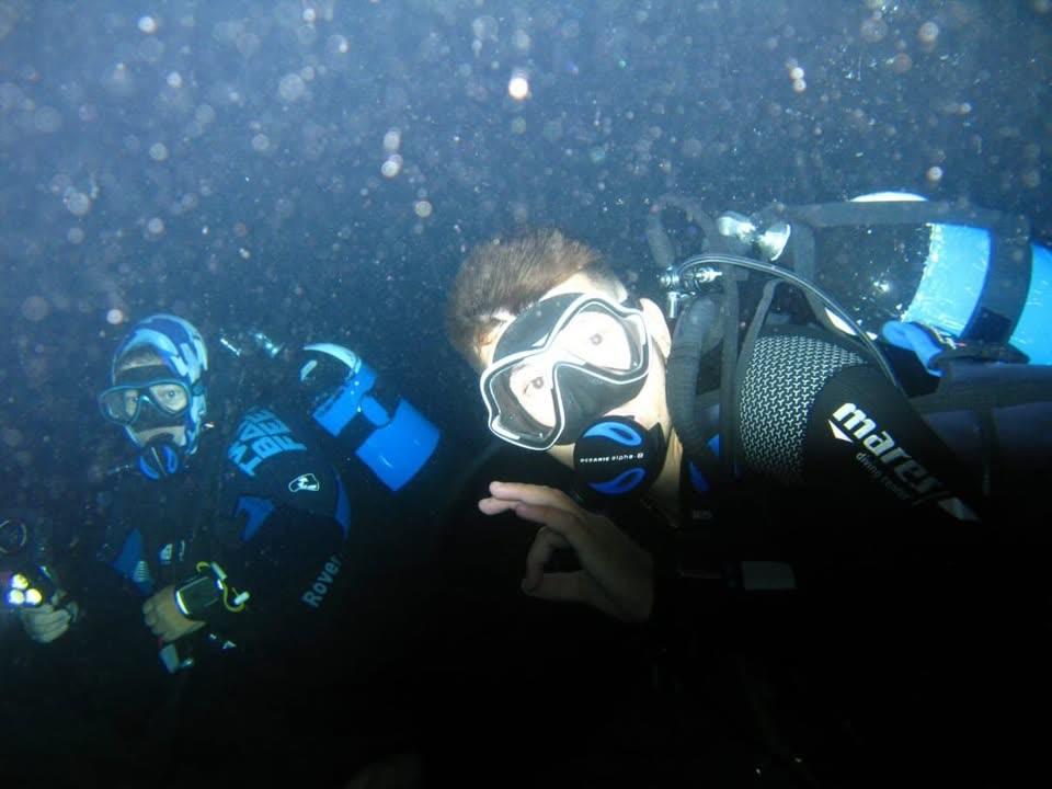 Night dive at Mades Bay — divers under torch light